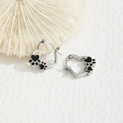 NOVA – Elegant Huggie Earrings with Heart & Paw in Silver Look and Black Enamel for a Stylish Appearance